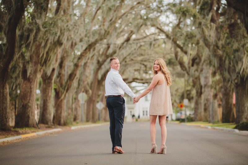 couple looking back while walking down Magnolia Ave in St. Augustine