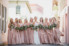 bride and bridesmaids in pink dress and bouquets with ribbon