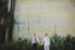 two grooms standing under south carolina aquarium sign holding hands