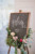 chalk board welcome sign with forals around it