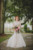 bride standing in front of ribault club holding bouquet