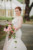 bride standing to the side holding wild floral bouquet