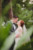 bride and groom about to kiss standing in greenery