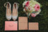 wedding invitation, bridal shoes and wedding bouquet