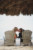 bride and groom sitting in wooden chairs kissing