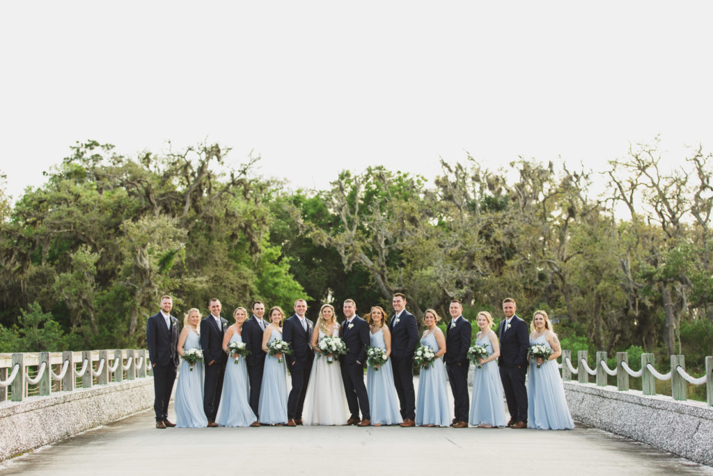 wedding party lined up standing on bridge