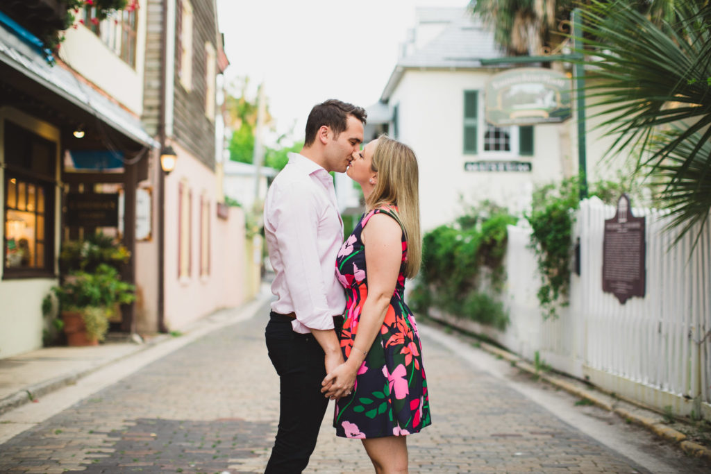 engaged couple kissing on streets of st. augustine
