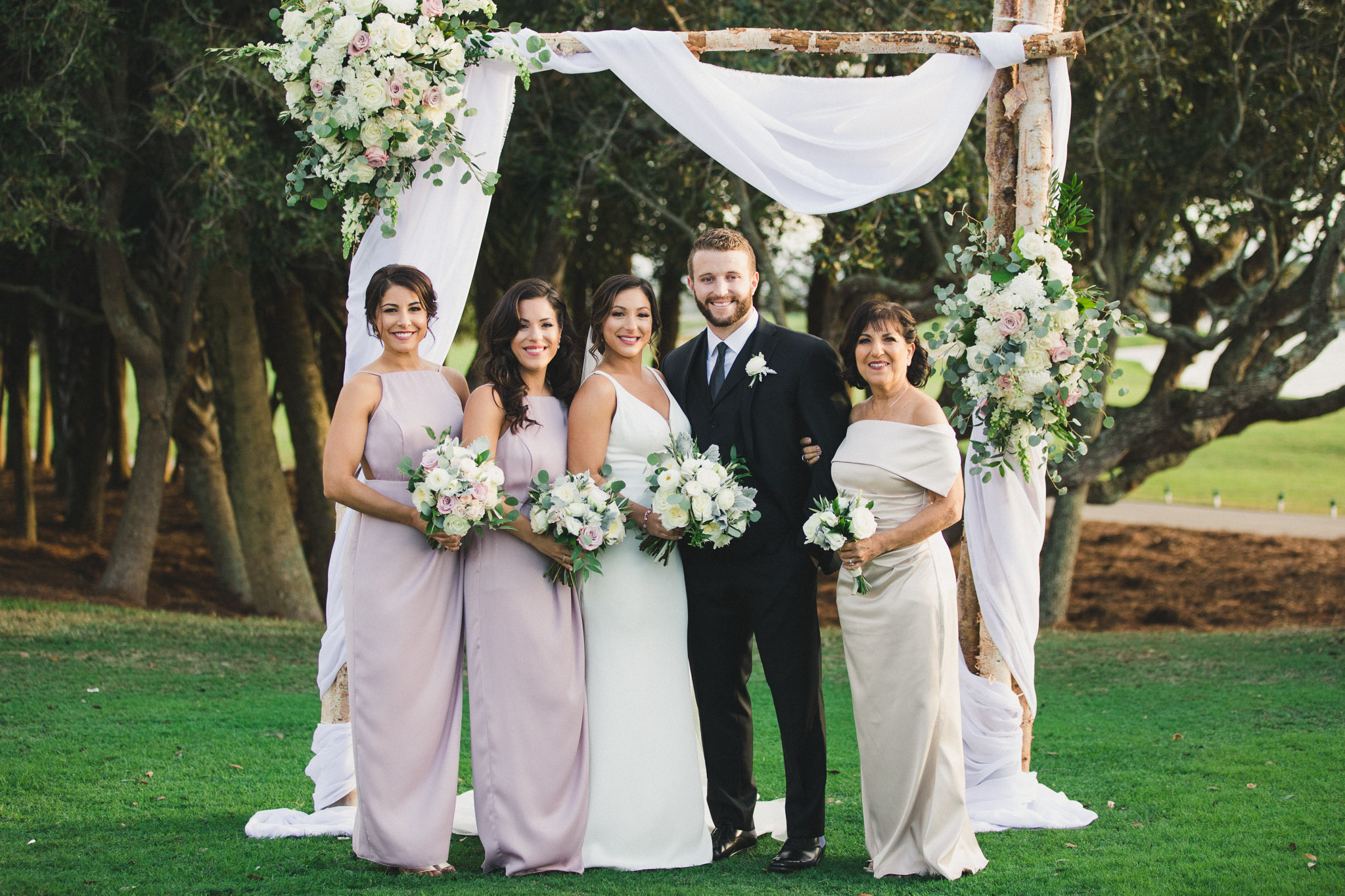 family formal portraits at ponte vedra inn and club spa lawn post ceremony