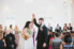 bride and groom give each other high five in middle of aisle after ceremony at white room villa blanca
