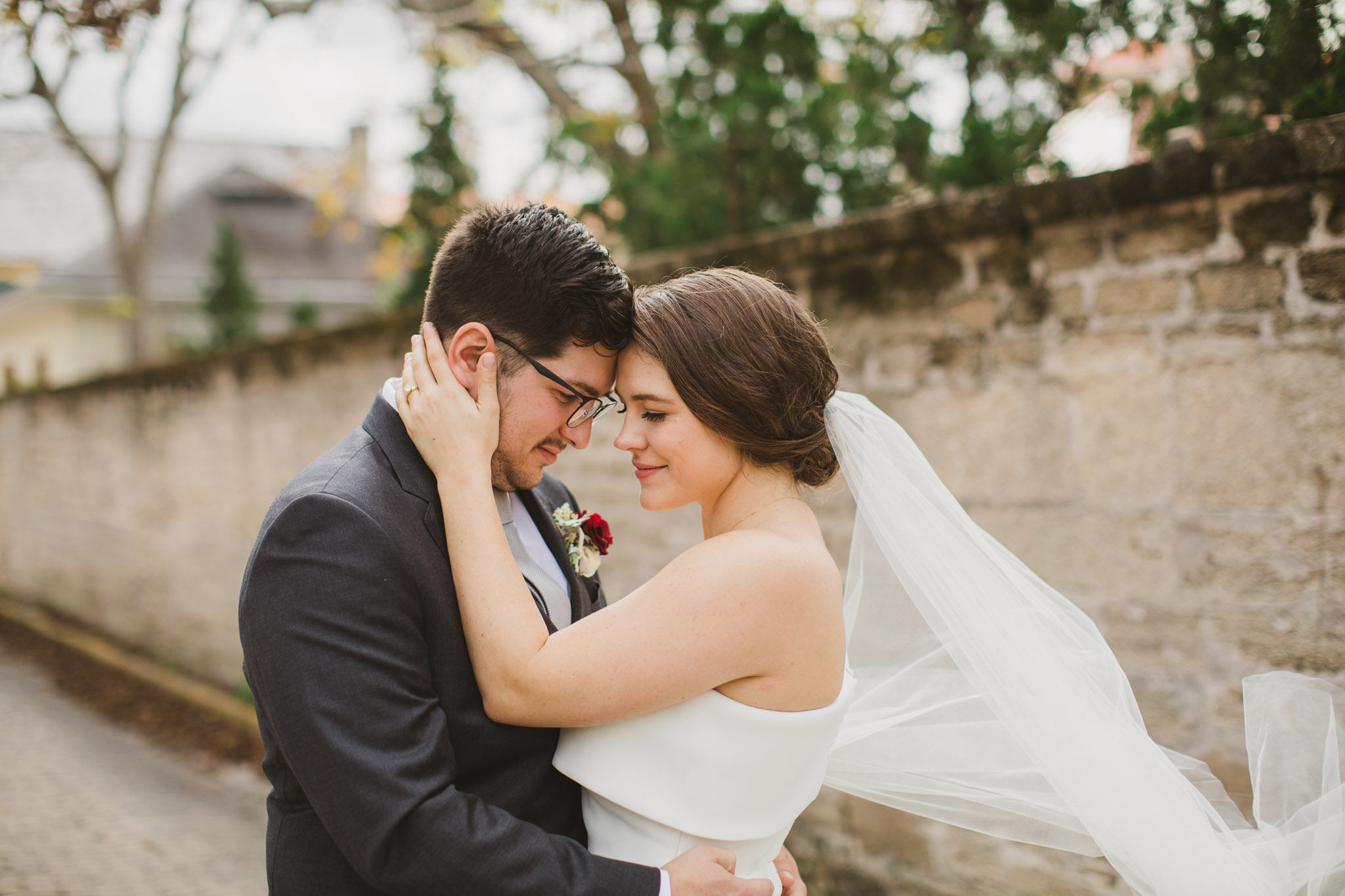 bride pulling groom in for a kiss