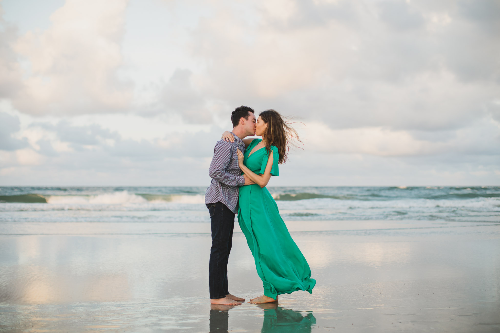 man giving woman a kiss during sunset photos on the beach