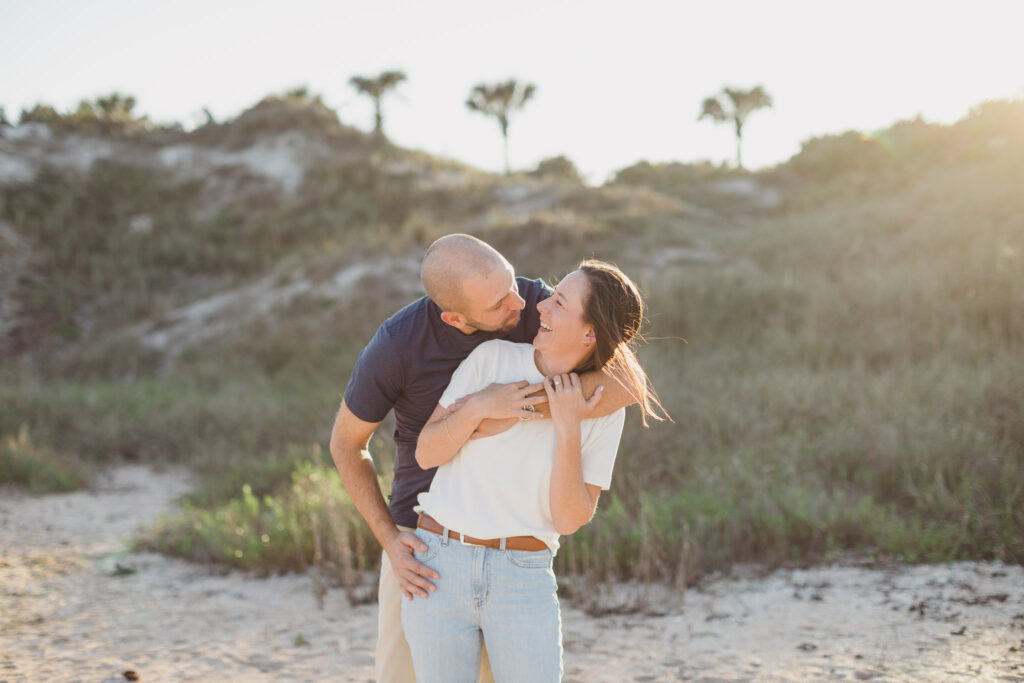 couple playing on ponte vedra beach for engagement photos