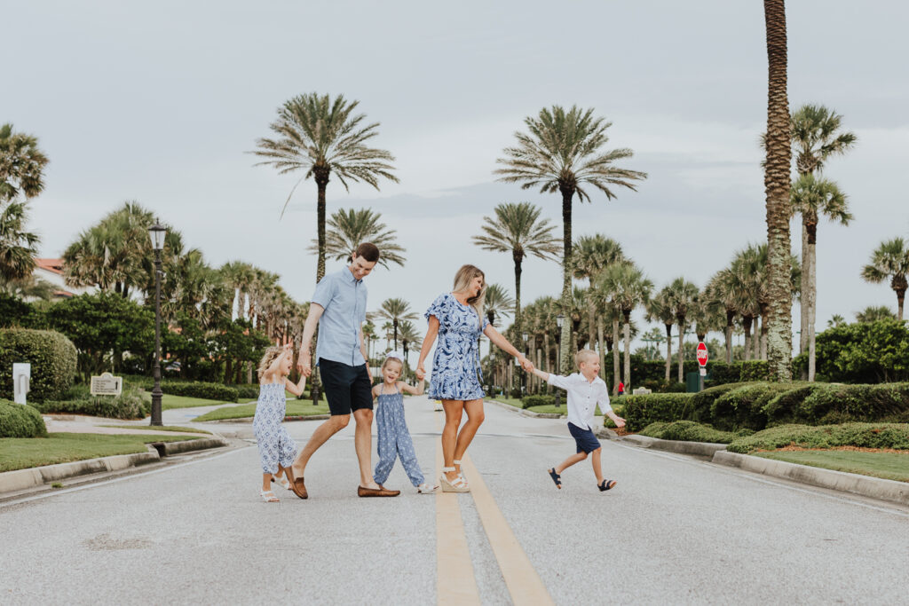 family of five walking across street together in ponte vedra for family session 