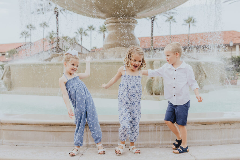 triplets being silly on fountain step of the ponte vedra inn and club