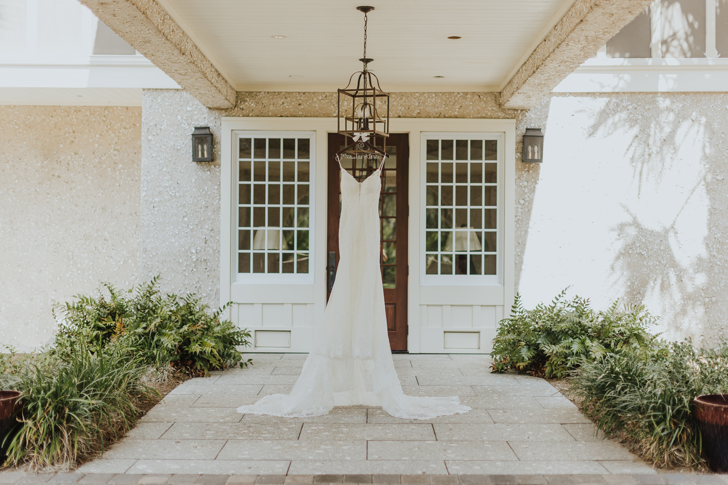 bridal gown hanging at entrance of oyster bay yacht club