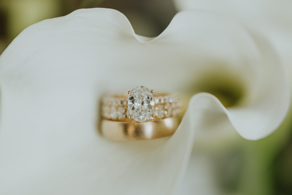 engagement ring and wedding bands in white floral