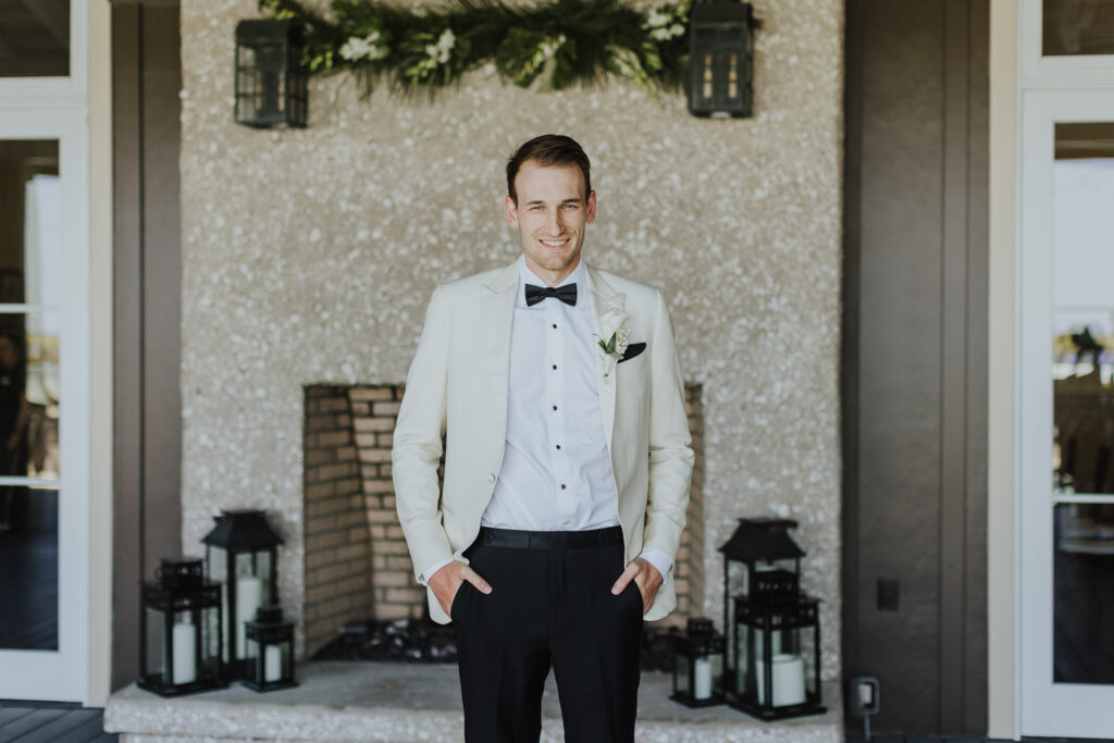 portrait of groom standing on deck of oyster bay yacht club