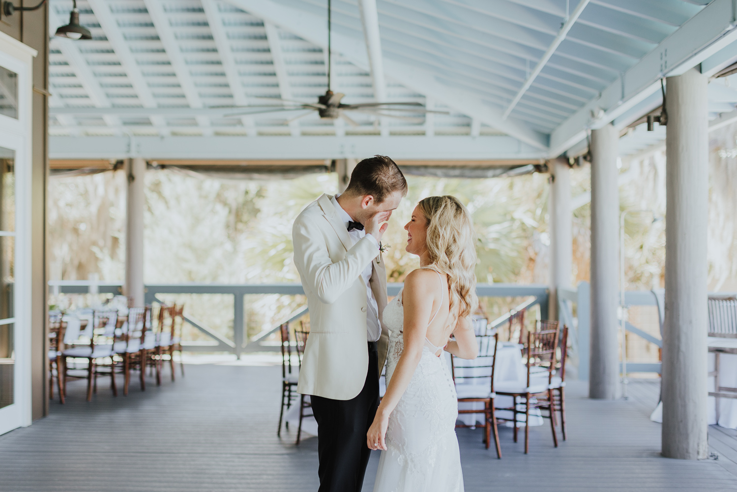 groom wiping away a tear after seeing his bride for the first time on their wedding day at oyster bay on amelia island