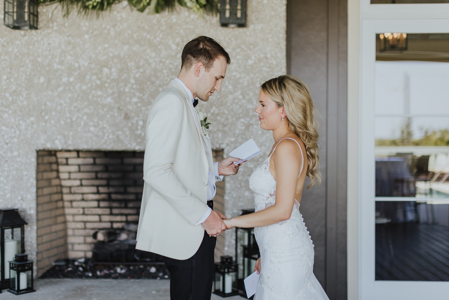 groom reading personal vows during their first look at oyster bay yacht club 