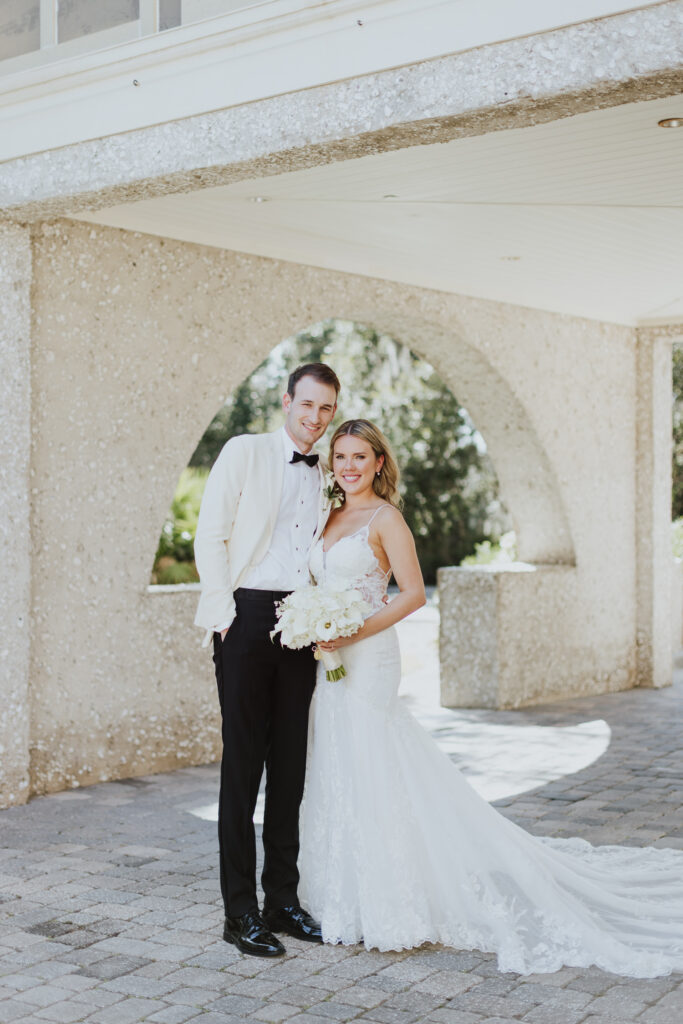 groom and bride portrait in front of oyster bay yacht club before their ceremony