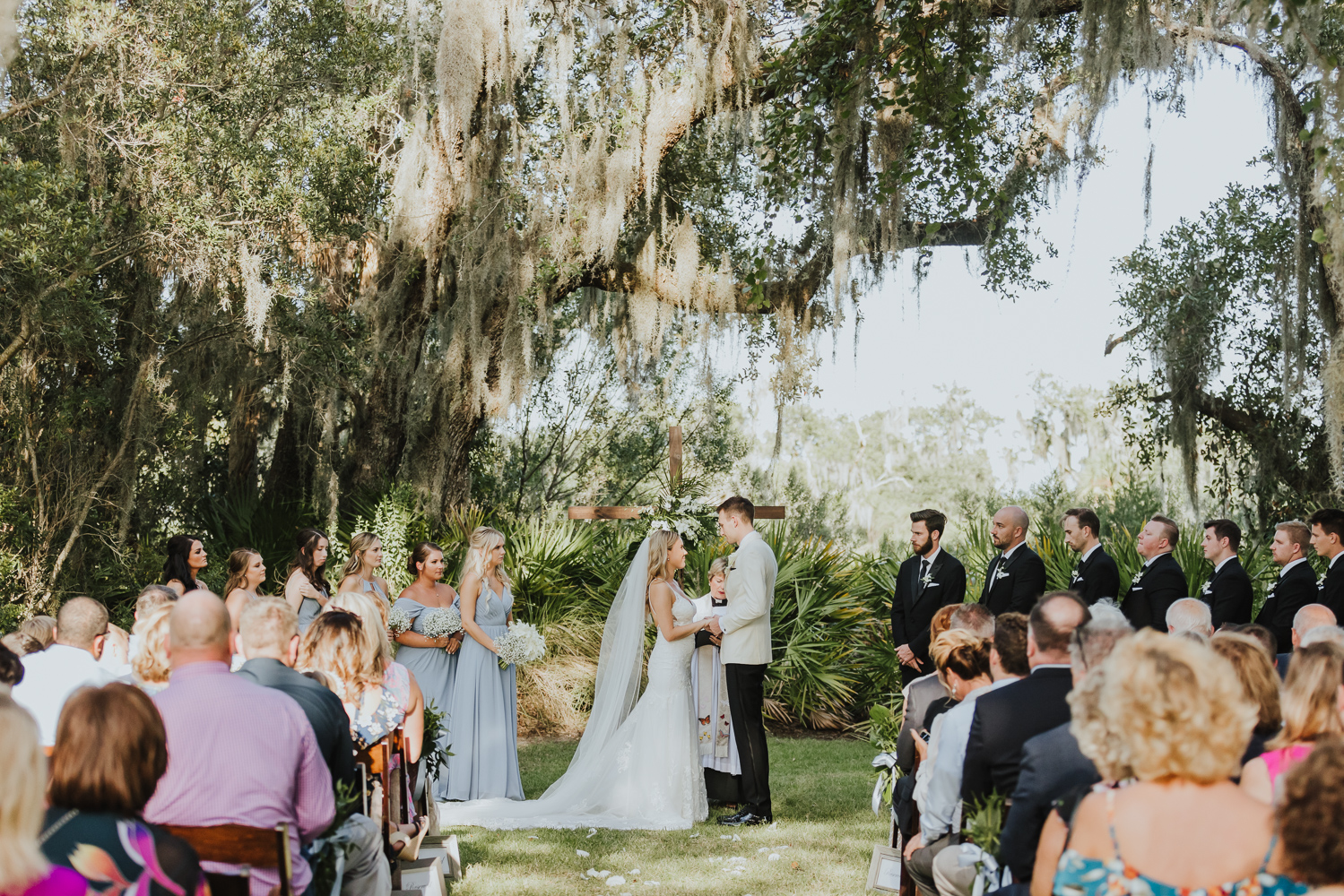 bride and groom at wooden cross alter of oyster bay outside ceremony 