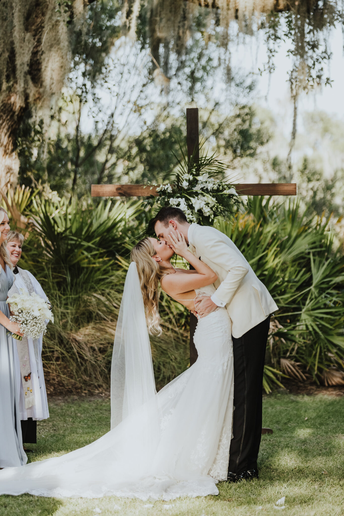 bride and groom kissing at alter of ceremony on oyster bay yacht club lawn 