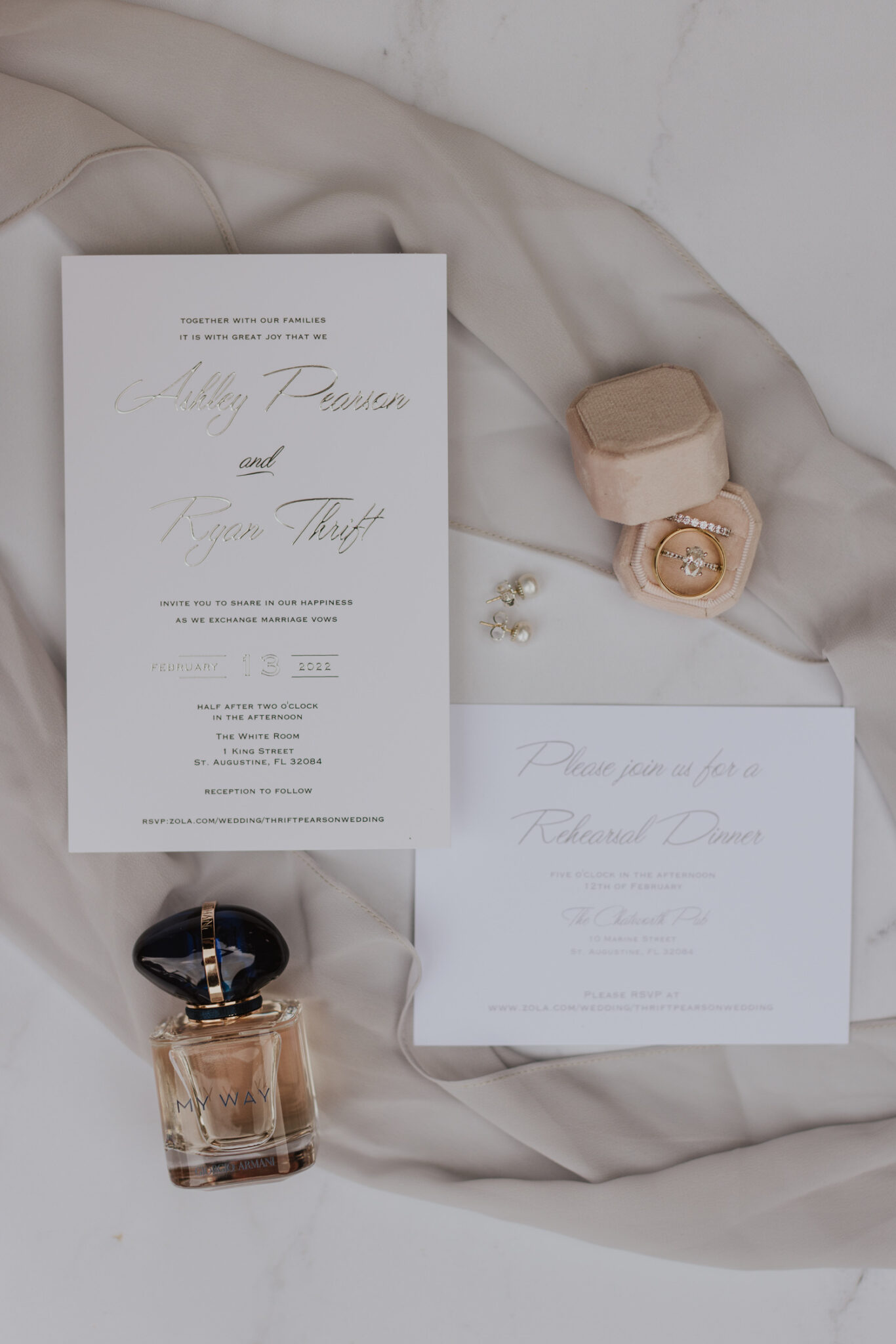 white and gold wedding invitation suite with pink accents on layflat