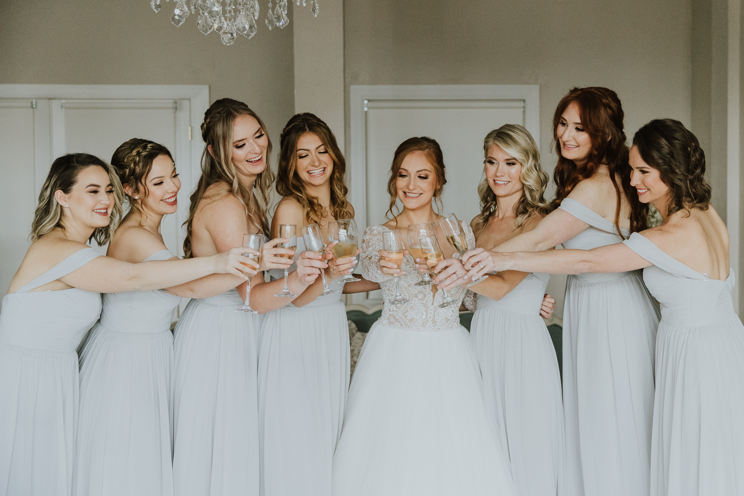 bride and bridesmaids cheersing together