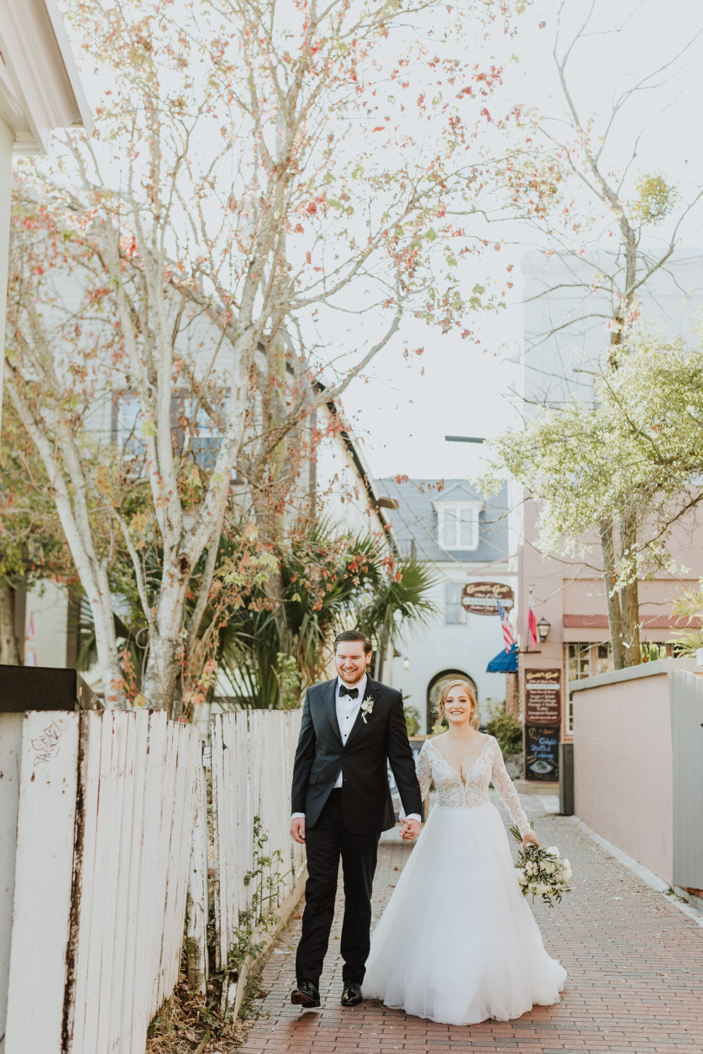 groom and bride walking down alley of downtown st. augustine 