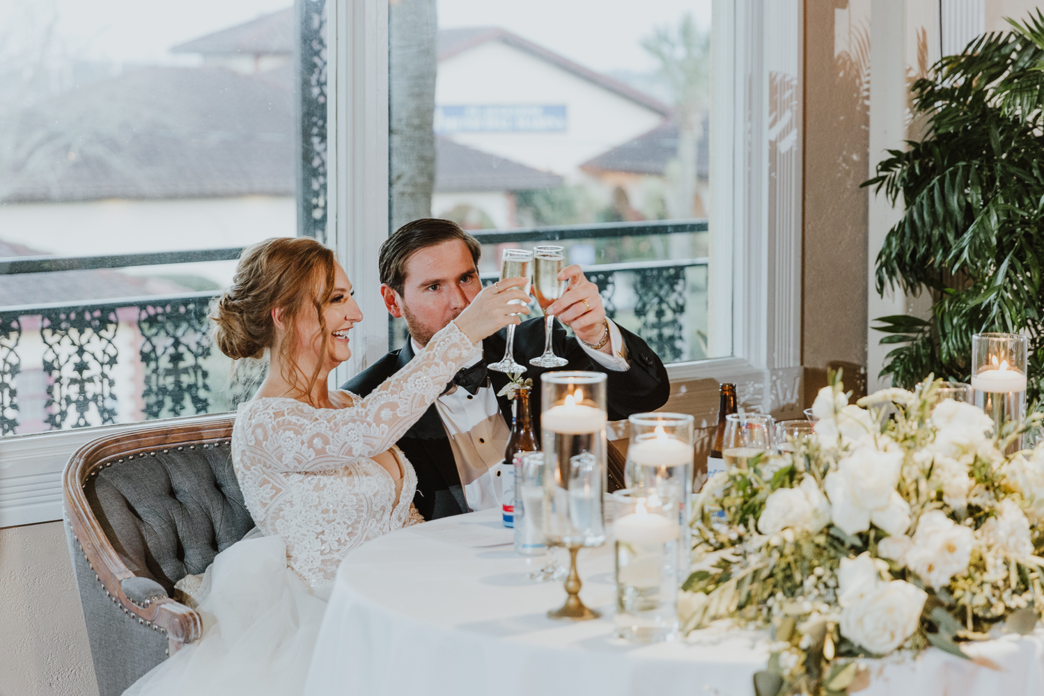 bride and groom cheersing their glasses after the wedding speeches
