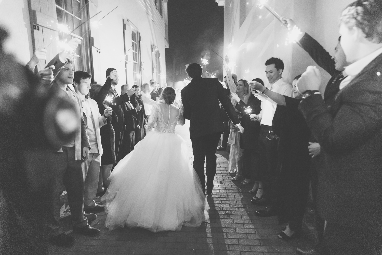 bride and groom walking down the sparkler exit after their st. augustine wedding