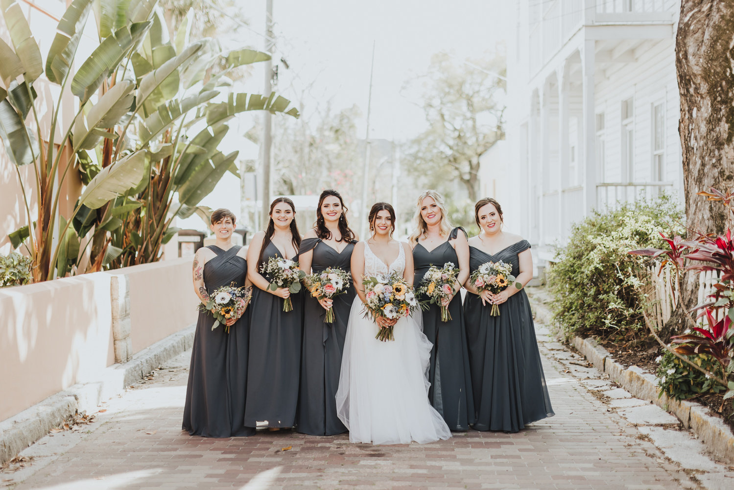 bride and bridesmaids lined up in st. augustine street