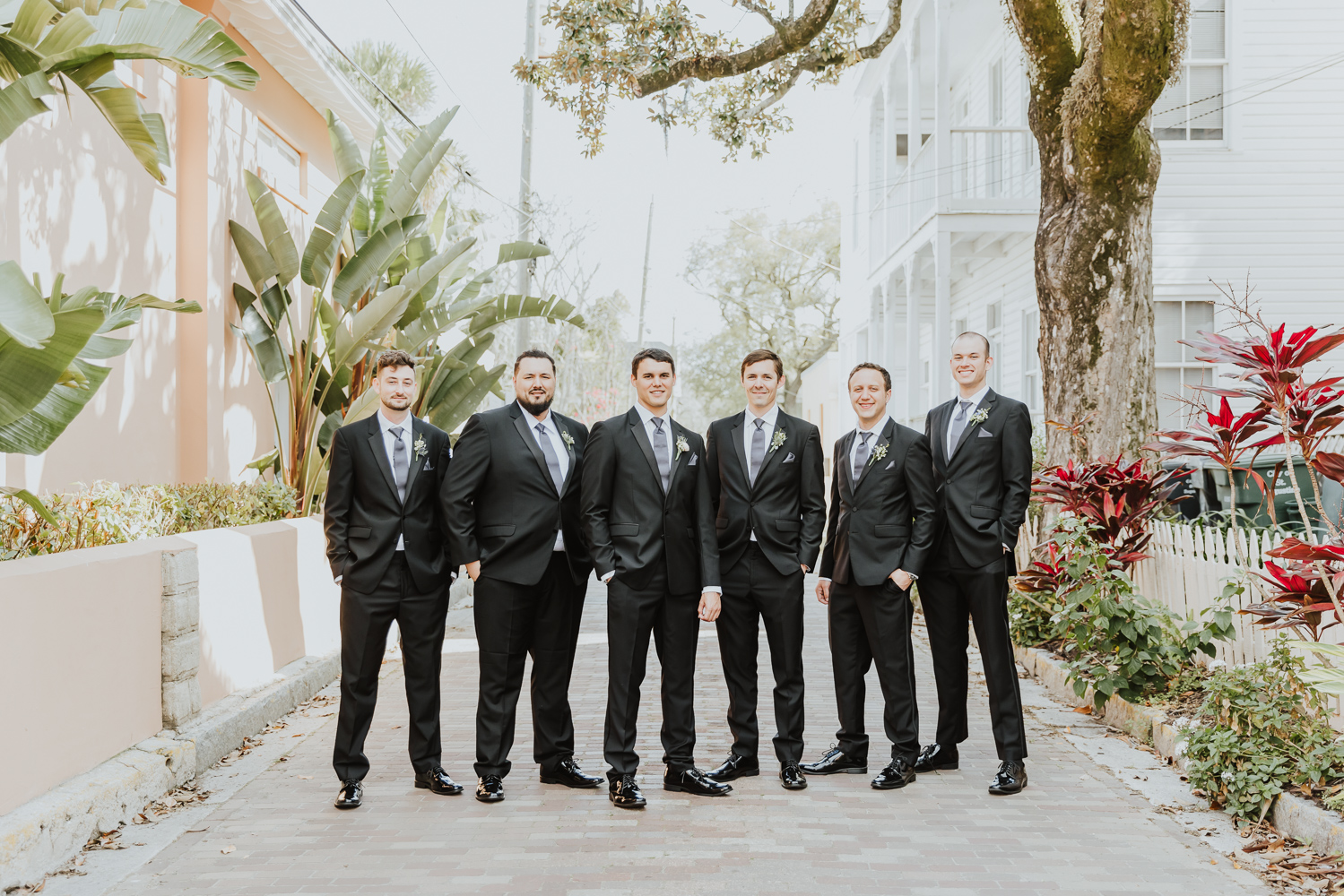 groom standing with his groomsmen in middle of st. augustine street 