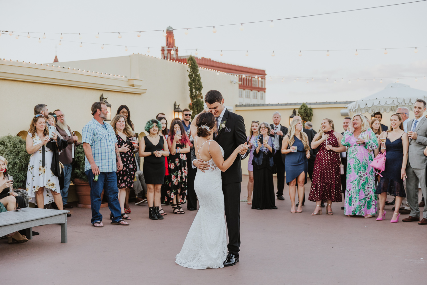 bride and groom sharing their first dance on the white room rooftop reception