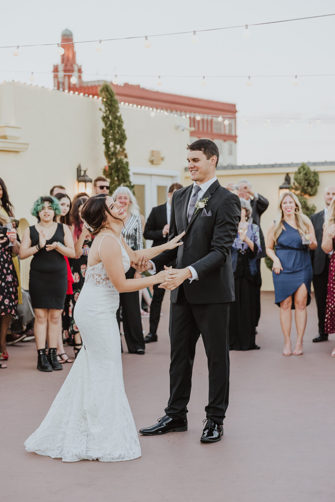 bride laughing with groom during their first dance of the white room 