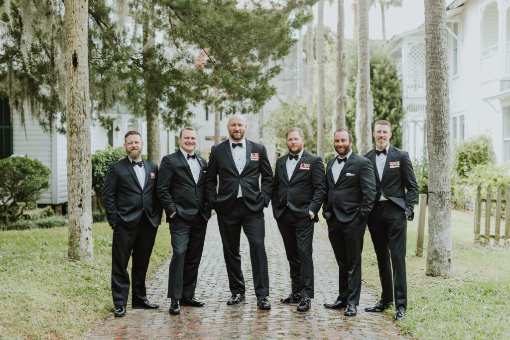 groom with groomsmen standing in palm row in st augustine