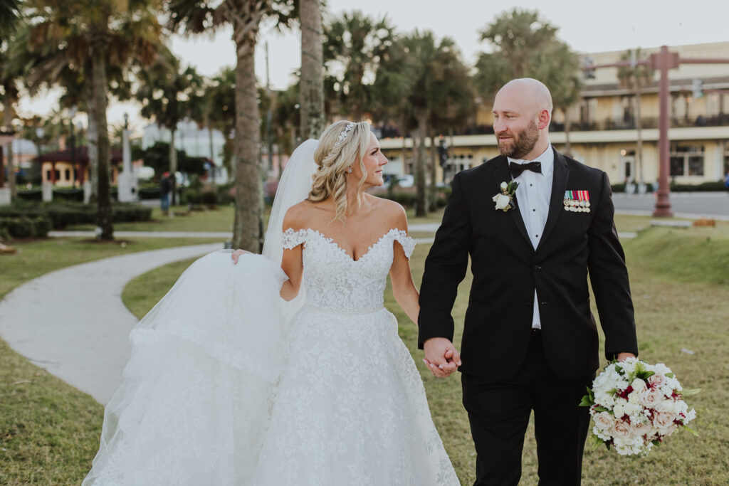 bride and groom portrait in downtown st. augustine with the white room building in the background 