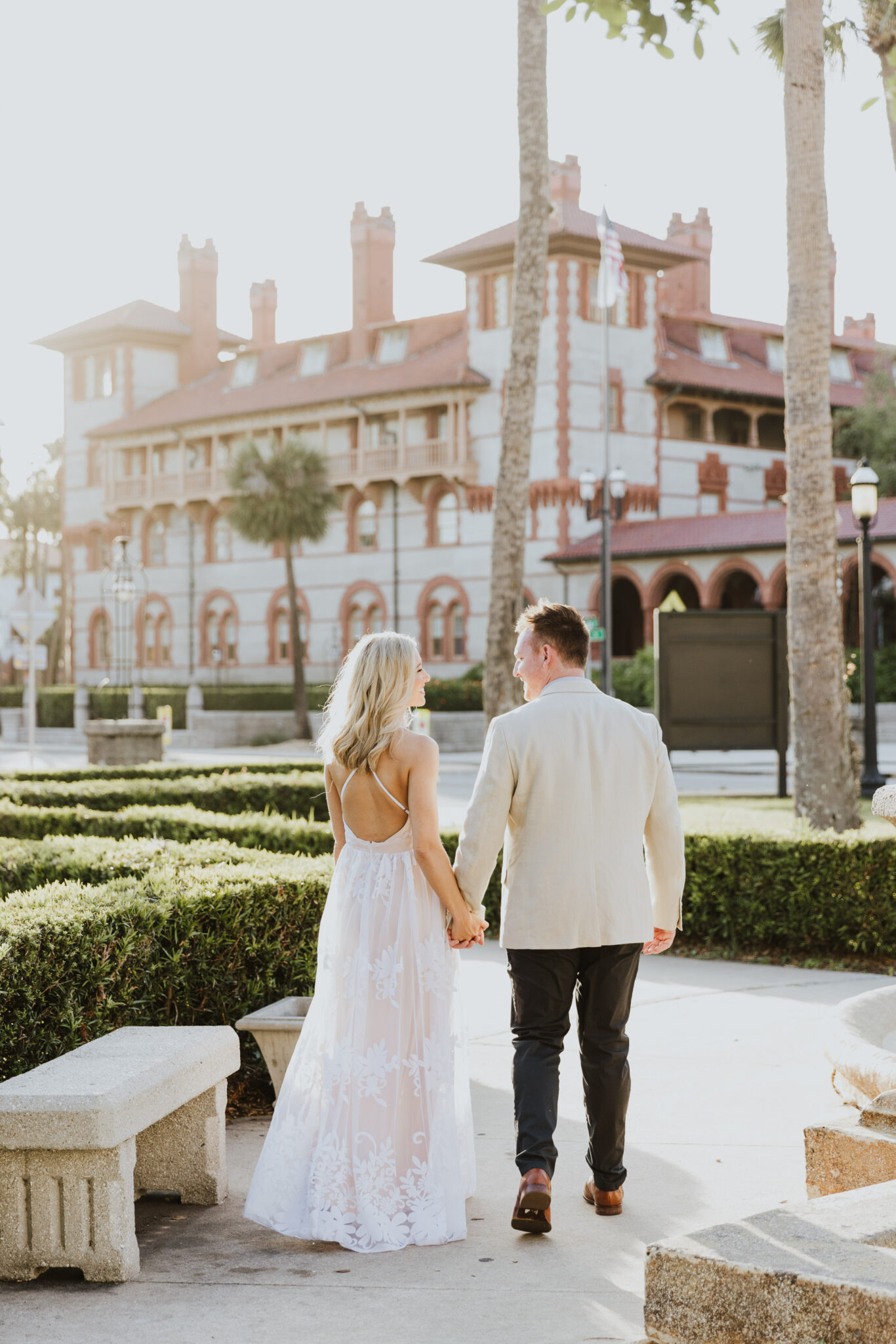 couple holding hands walking away during st. augustine engagement session 