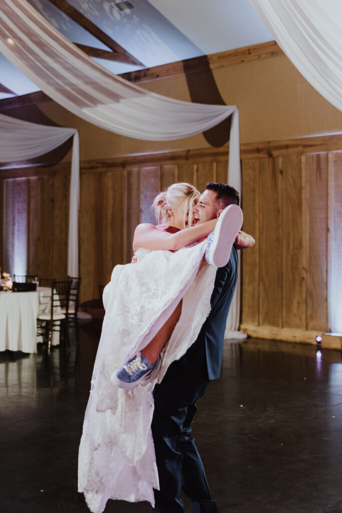 groom carrying bride during last dance together at bowing oaks wedding