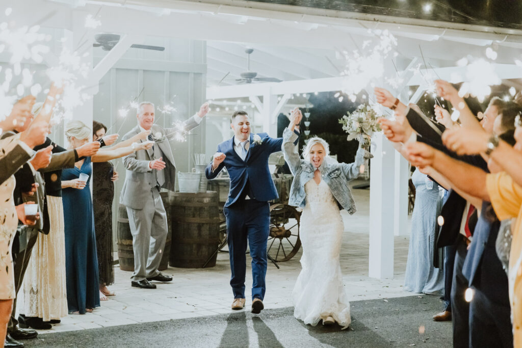 groom and bride walking through sparkler exit at bowing oaks wedding venue