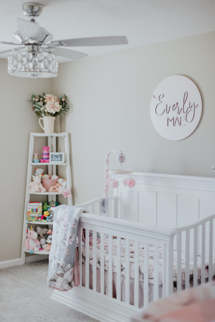 baby's nursery with whites and creams and touches of pink in jacksonville, fl
