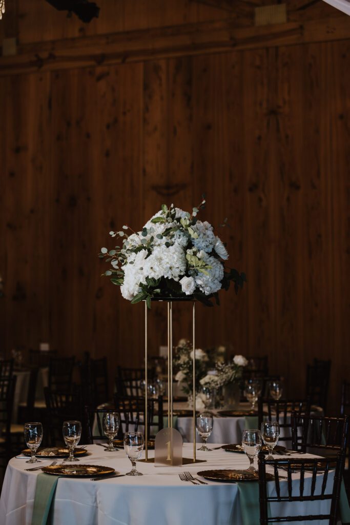 bowing oaks reception tall centerpiece with white florals and greenery