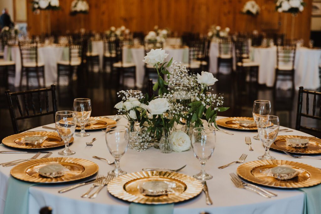 white florals and gold details at wedding reception at bowing oaks