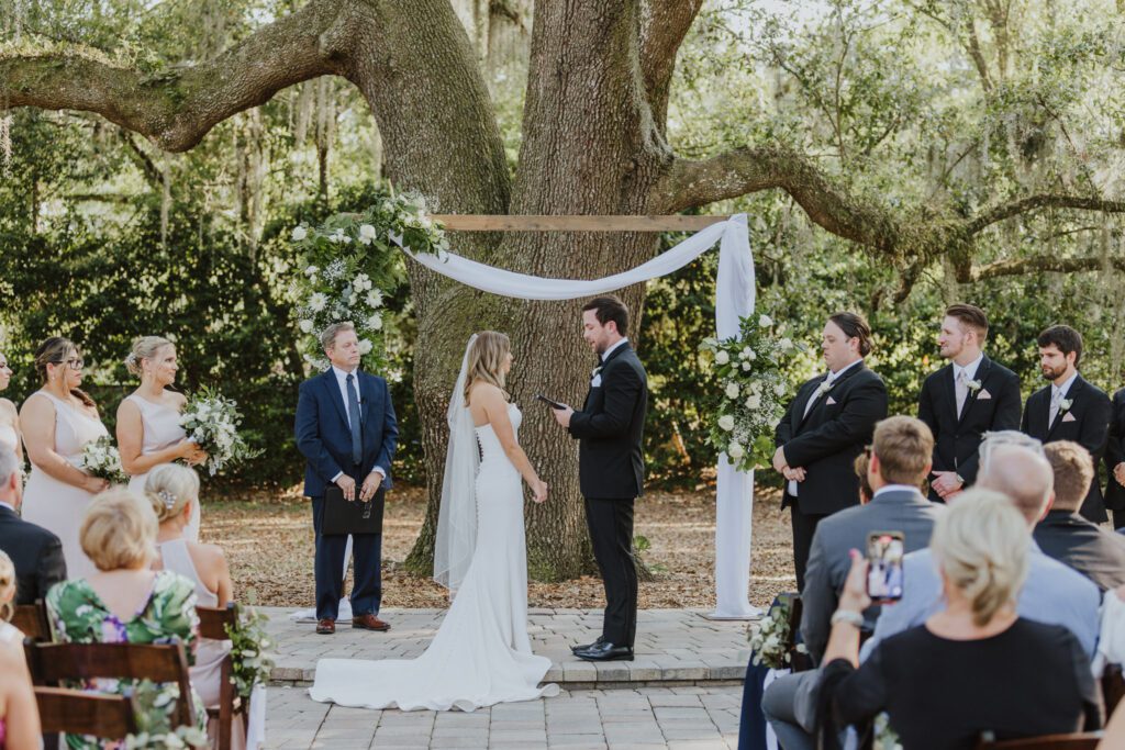 groom reading vows to bride at ceremony area of bowing oaks in jacksonville