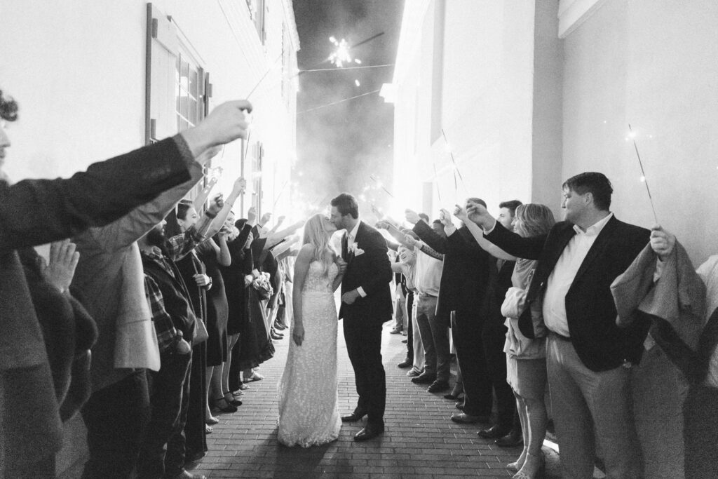 bride and groom kissing during their sparkler exit in downtown st. augustine