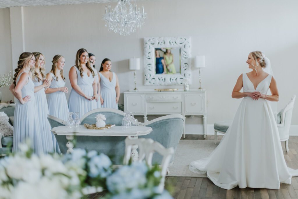 bride having first look with bridesmaids in the white room bridal suite