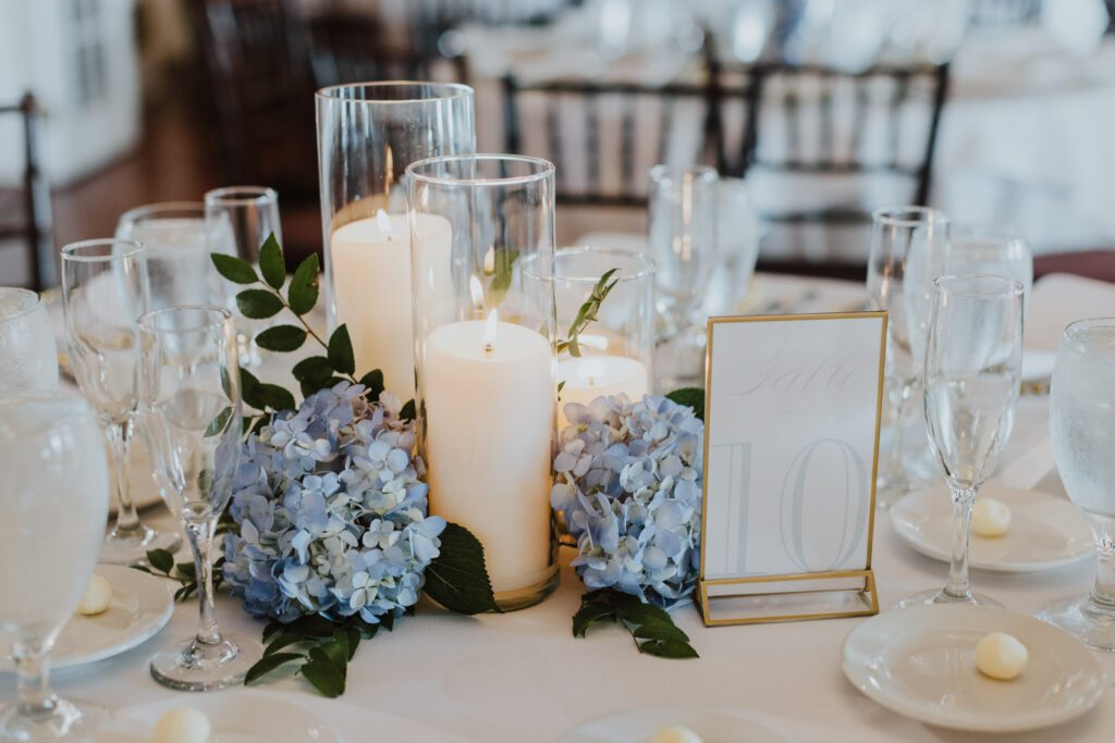 blue hydrangeas and white candles as a reception centerpiece 