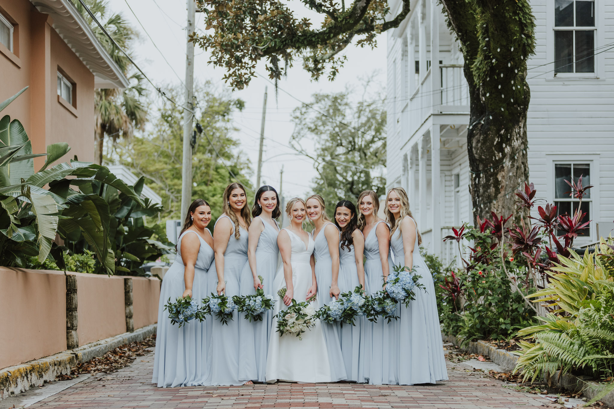bride with bridesmaids holding bouquets in middle of street of st. augustine 