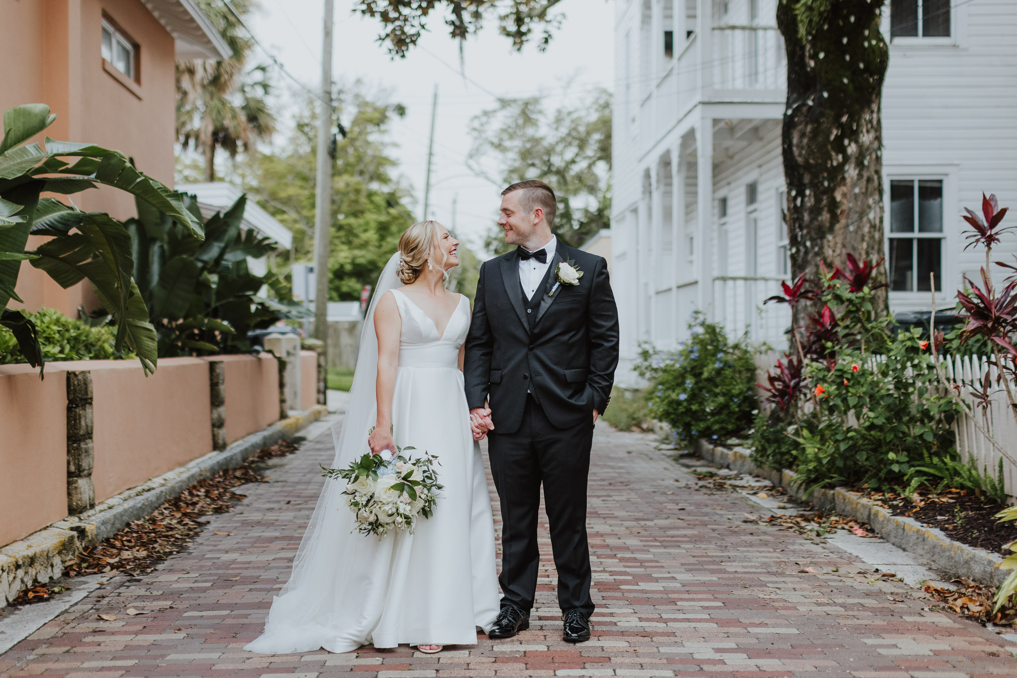 bride and groom looking at each other standing in middle of st. augustine downtown streets
