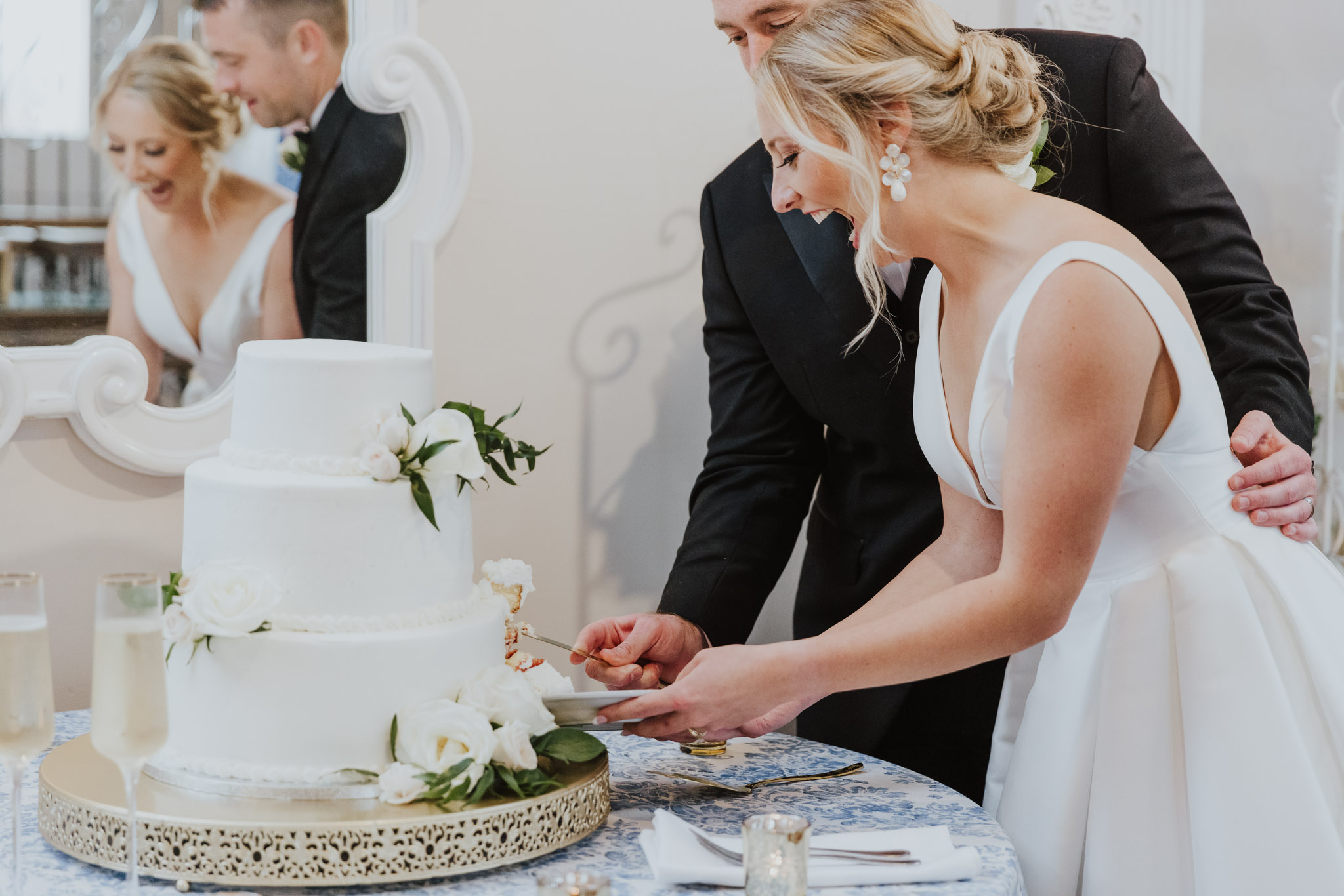 bride and groom cutting their cake at the white room loft wedding reception